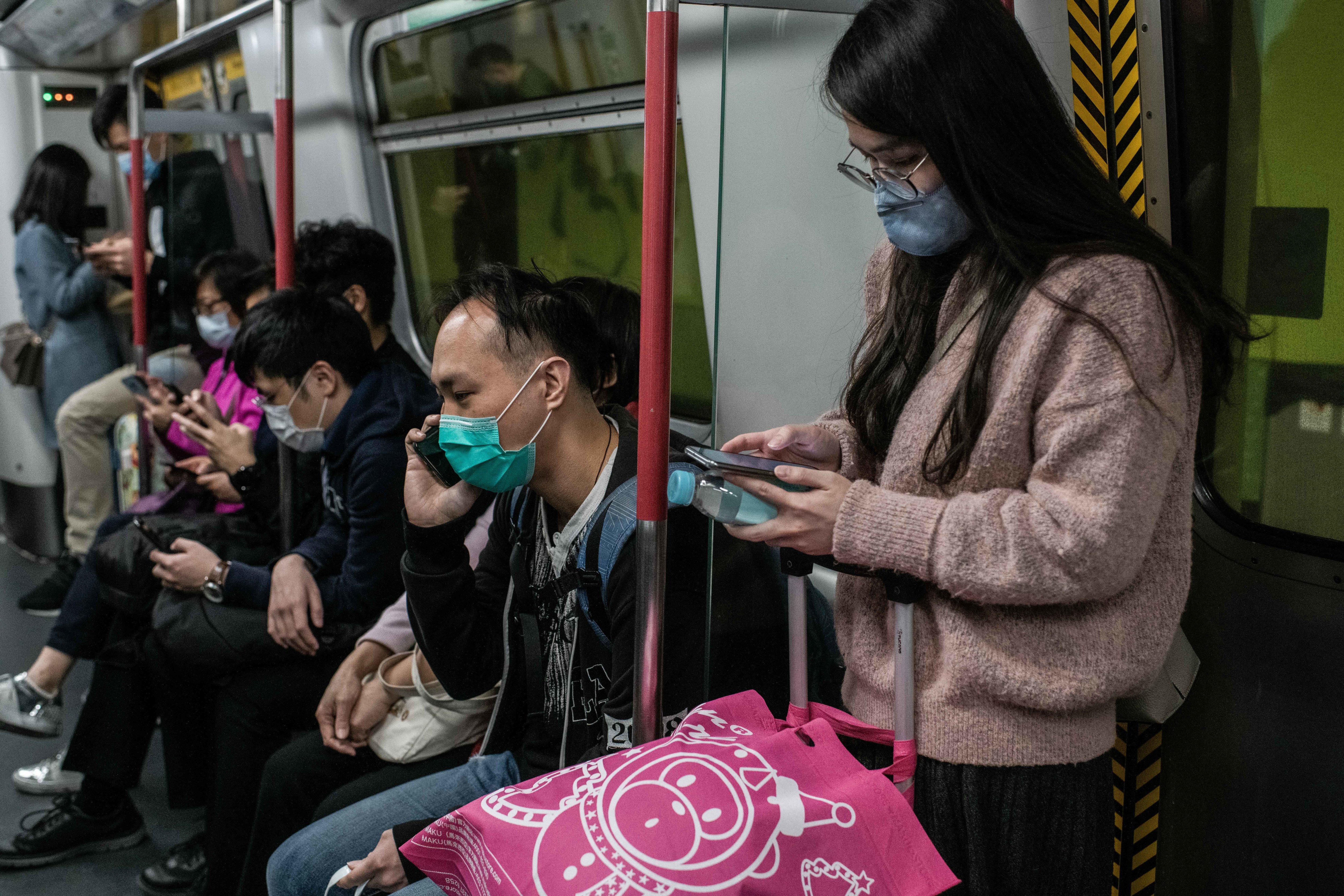 Pasajeros con mascarillas se transportan en el metro de Hong Kong
