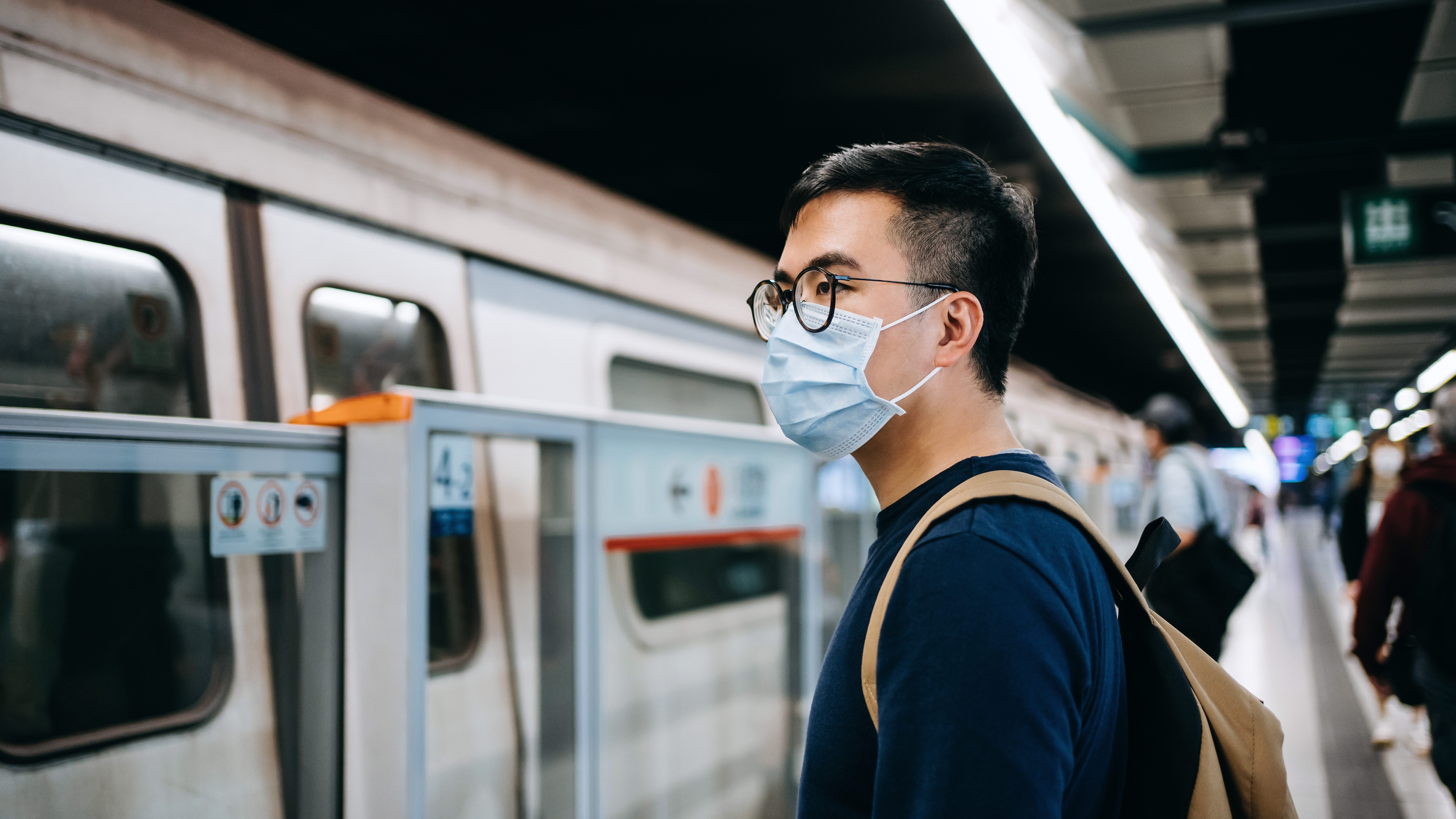 Asian mask. Smoking in public transport. Man on the иглы. Mental Health during Quarantine. Asian oldman looking at Phone in Subway.